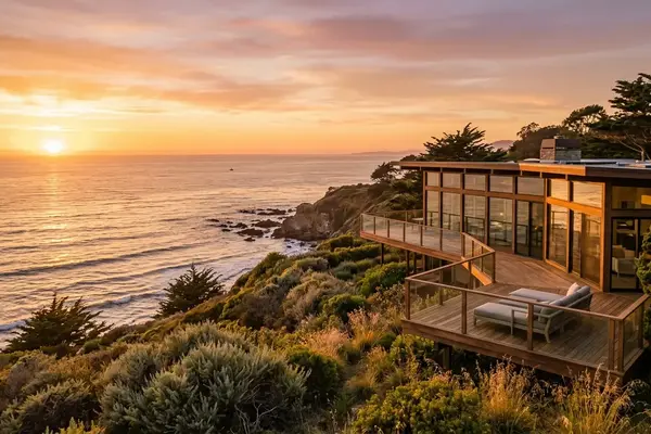Home near the ocean with the sun setting
